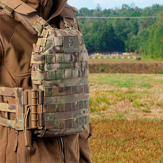 A close-up of a tactical plate carrier worn by a person, showcasing its utility for why use plate carrier at shooting range.
