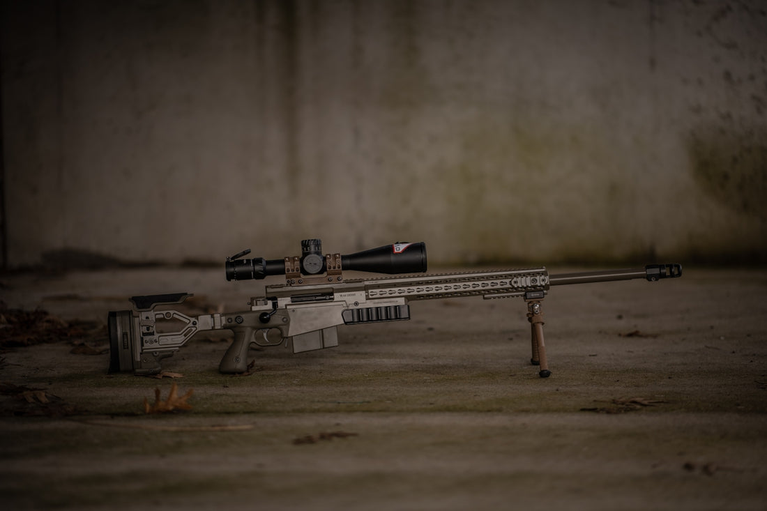 a rifle laying on the ground with a scope