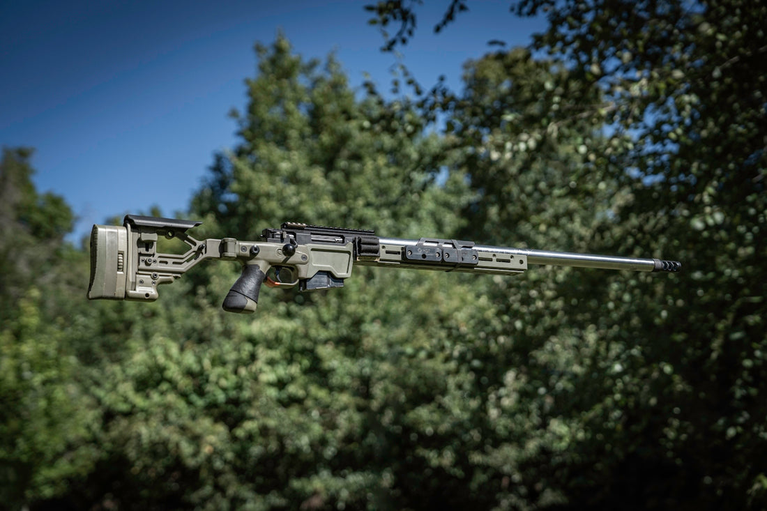 A machine gun in the air with trees in the background