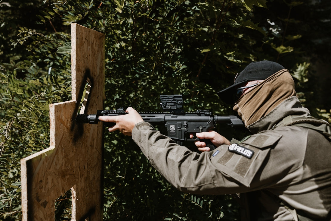 Man aiming rifle at target in woods