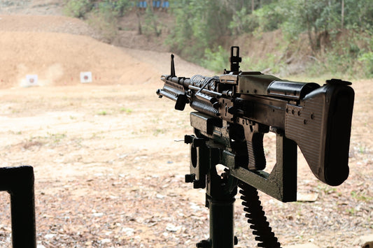 Machine gun mounted on a stand at a shooting range.