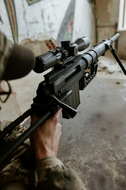 Soldier aiming a sniper rifle with scope