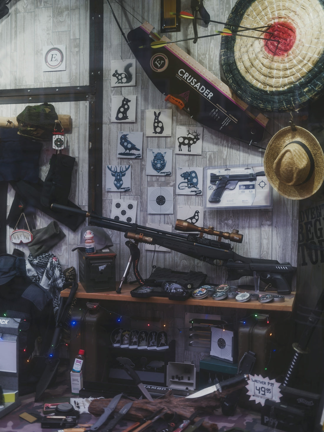 Rifle and archery equipment displayed on wall